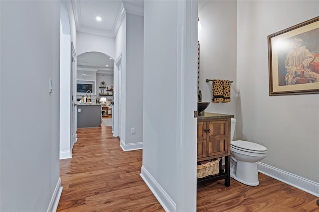 4 Old Oak Dr N, Palm Coast, FL 32137 - hallway with crown molding, wood finished floors, arched walkways, and recessed lighting