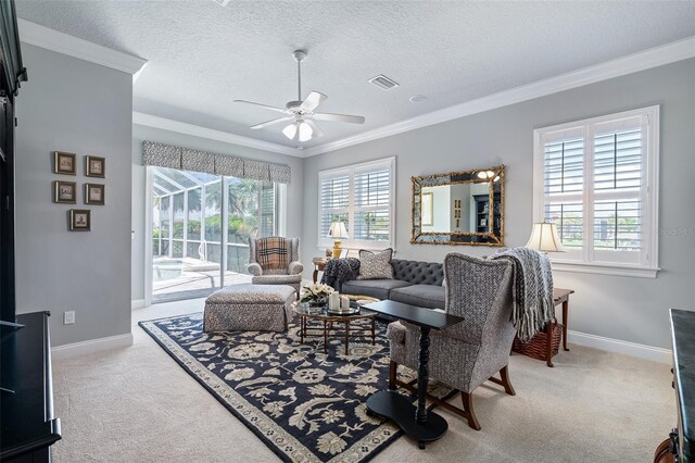 4 Old Oak Dr N, Palm Coast, FL 32137 - carpeted living area featuring plenty of natural light, ornamental molding, ceiling fan, and a textured ceiling