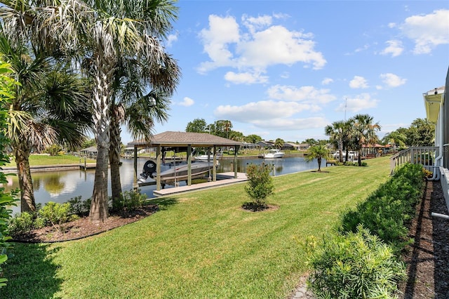 4 Old Oak Dr N, Palm Coast, FL 32137 - dock with boat lift, a water view, and a yard