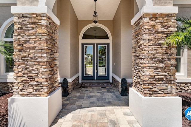 4 Old Oak Dr N, Palm Coast, FL 32137 - doorway to property with stone siding, stucco siding, and french doors