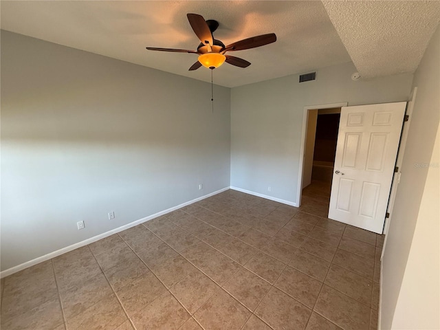 59 Rivers Edge Ln Unit 59, Palm Coast, FL 32137 - tiled empty room with a textured ceiling and a ceiling fan