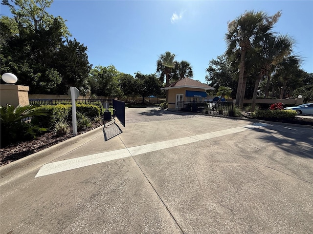 59 Rivers Edge Ln Unit 59, Palm Coast, FL 32137 - view of concrete street featuring curbs, a gate, and a gated entry