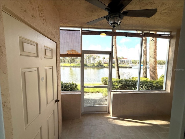 59 Rivers Edge Ln Unit 59, Palm Coast, FL 32137 - unfurnished sunroom featuring a water view, healthy amount of natural light, and a ceiling fan
