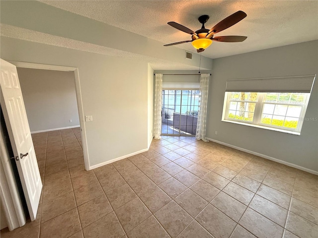 59 Rivers Edge Ln Unit 59, Palm Coast, FL 32137 - tiled empty room with a textured ceiling and ceiling fan