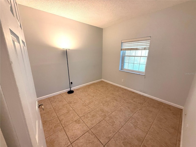 59 Rivers Edge Ln Unit 59, Palm Coast, FL 32137 - empty room with a textured ceiling and light tile patterned floors