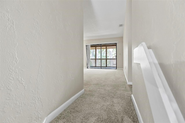 14 Oakmont Ct Unit 14, Palm Coast, FL 32137 - hallway featuring carpet floors and baseboards