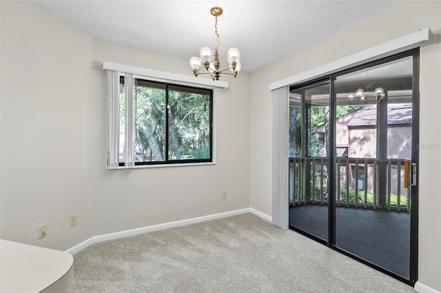 14 Oakmont Ct Unit 14, Palm Coast, FL 32137 - carpeted empty room featuring a chandelier and plenty of natural light