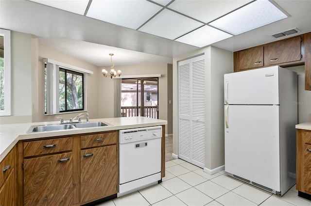 14 Oakmont Ct Unit 14, Palm Coast, FL 32137 - kitchen featuring white appliances, a chandelier, light tile patterned flooring, and light countertops