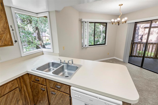 14 Oakmont Ct Unit 14, Palm Coast, FL 32137 - kitchen with white dishwasher, carpet, light countertops, a chandelier, and a peninsula