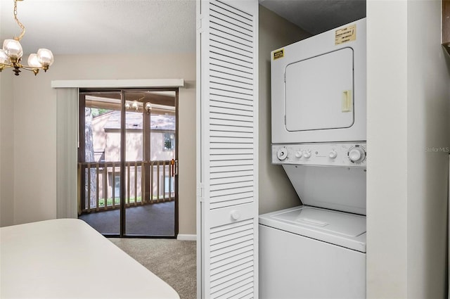 14 Oakmont Ct Unit 14, Palm Coast, FL 32137 - laundry area with stacked washer and clothes dryer, carpet floors, and a chandelier