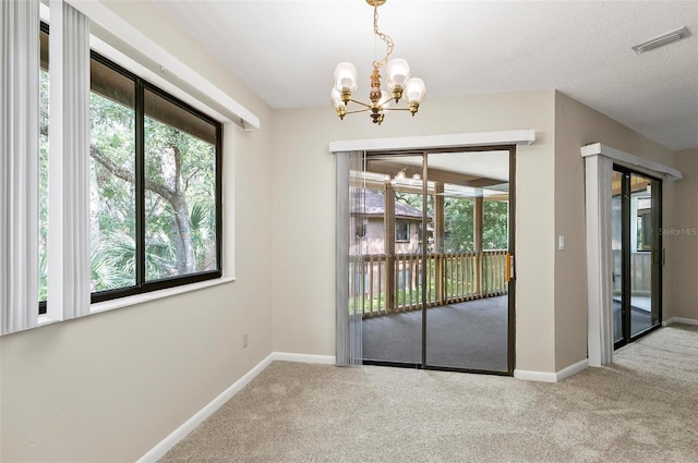 14 Oakmont Ct Unit 14, Palm Coast, FL 32137 - unfurnished dining area featuring a chandelier and carpet floors