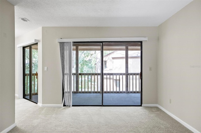 14 Oakmont Ct Unit 14, Palm Coast, FL 32137 - spare room with carpet flooring, healthy amount of natural light, and a textured ceiling