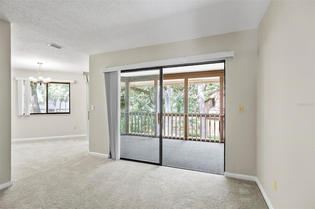 14 Oakmont Ct Unit 14, Palm Coast, FL 32137 - carpeted spare room featuring a chandelier and a textured ceiling