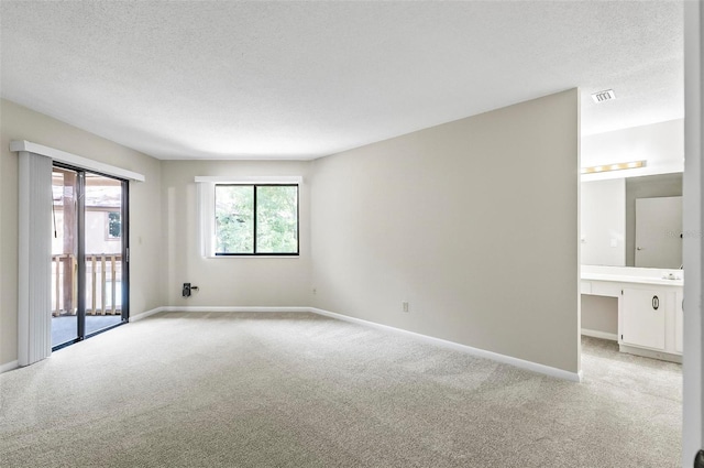 14 Oakmont Ct Unit 14, Palm Coast, FL 32137 - unfurnished room featuring light colored carpet and a textured ceiling