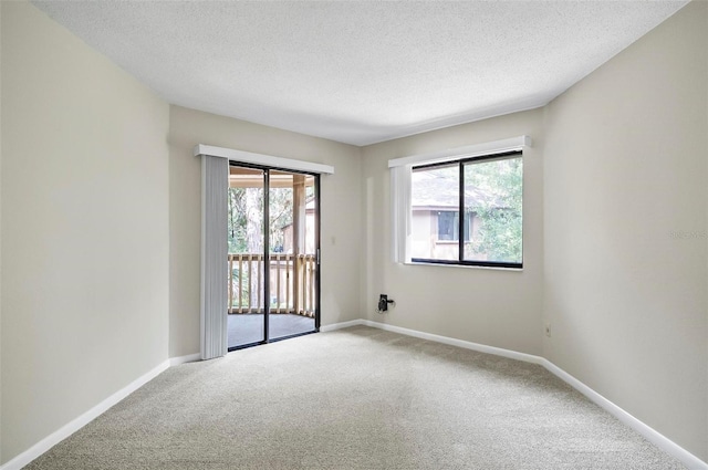 14 Oakmont Ct Unit 14, Palm Coast, FL 32137 - carpeted spare room featuring a textured ceiling and baseboards