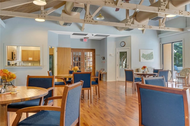 14 Oakmont Ct Unit 14, Palm Coast, FL 32137 - dining area with light wood-type flooring, beamed ceiling, high vaulted ceiling, and french doors