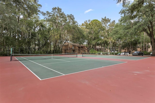 14 Oakmont Ct Unit 14, Palm Coast, FL 32137 - view of tennis court with community basketball court and view of wooded area