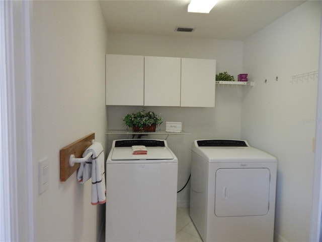 7 College Ct, Palm Coast, FL 32137 - laundry room featuring cabinet space, washing machine and clothes dryer, and light tile patterned floors