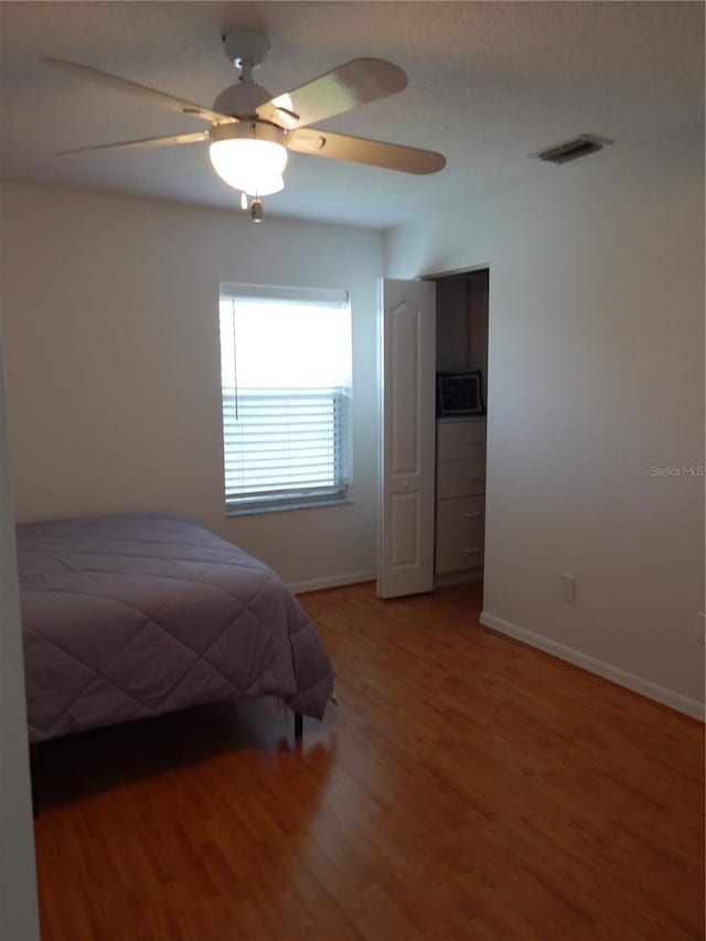 7 College Ct, Palm Coast, FL 32137 - bedroom with wood finished floors and ceiling fan