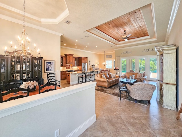 145 Heron Dr, Palm Coast, FL 32137 - living room featuring a raised ceiling, a chandelier, ceiling fan, ornamental molding, and wooden ceiling
