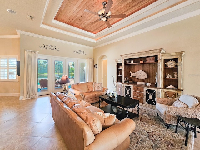 145 Heron Dr, Palm Coast, FL 32137 - living room with a tray ceiling, healthy amount of natural light, arched walkways, ceiling fan, and crown molding