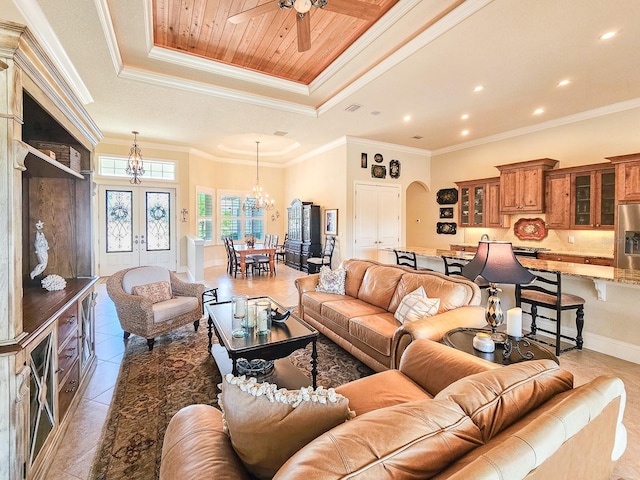 145 Heron Dr, Palm Coast, FL 32137 - living area featuring arched walkways, a raised ceiling, a chandelier, ceiling fan, and light tile patterned floors