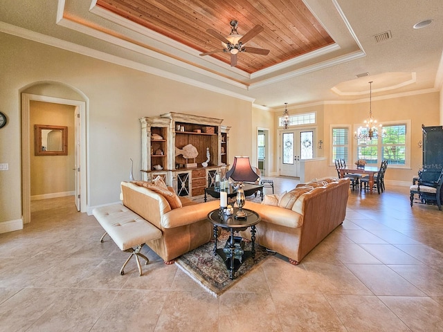 145 Heron Dr, Palm Coast, FL 32137 - living area featuring a tray ceiling, a chandelier, ornamental molding, a ceiling fan, and light tile patterned floors