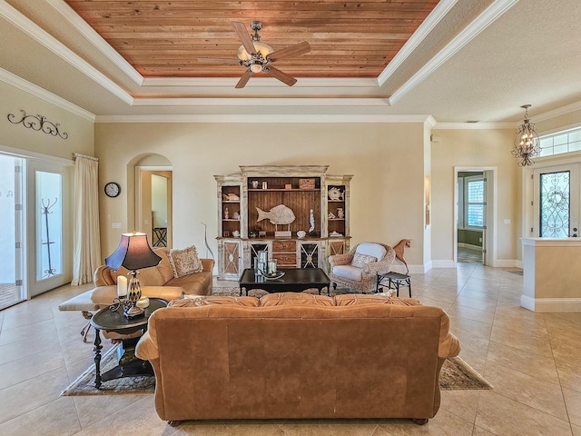 145 Heron Dr, Palm Coast, FL 32137 - tiled living room featuring a raised ceiling, arched walkways, crown molding, a ceiling fan, and wooden ceiling