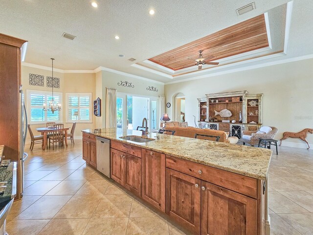 145 Heron Dr, Palm Coast, FL 32137 - kitchen featuring dishwasher, a tray ceiling, crown molding, plenty of natural light, and arched walkways