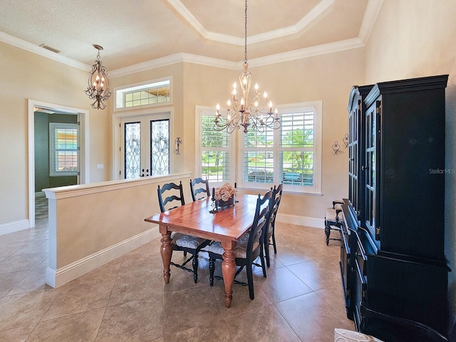 145 Heron Dr, Palm Coast, FL 32137 - dining space with a chandelier, healthy amount of natural light, crown molding, a raised ceiling, and light tile patterned flooring