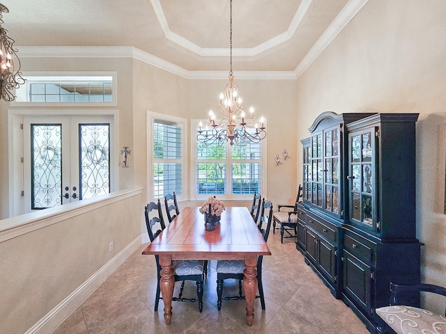 145 Heron Dr, Palm Coast, FL 32137 - dining room featuring a chandelier, a raised ceiling, tile patterned floors, and ornamental molding