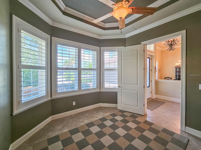 145 Heron Dr, Palm Coast, FL 32137 - spare room featuring crown molding, a chandelier, tile patterned flooring, a ceiling fan, and a tray ceiling