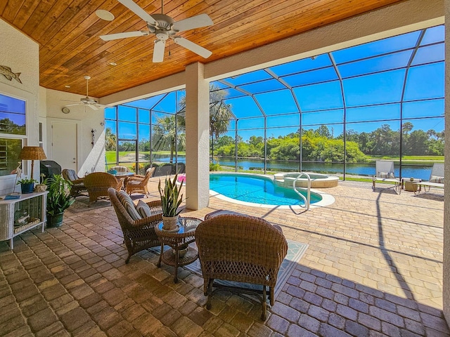 145 Heron Dr, Palm Coast, FL 32137 - view of patio / terrace with a ceiling fan, a pool with connected hot tub, a lanai, a water view, and outdoor dining space