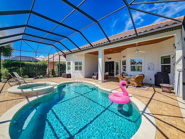 145 Heron Dr, Palm Coast, FL 32137 - view of swimming pool featuring a patio, a pool with connected hot tub, a ceiling fan, and glass enclosure