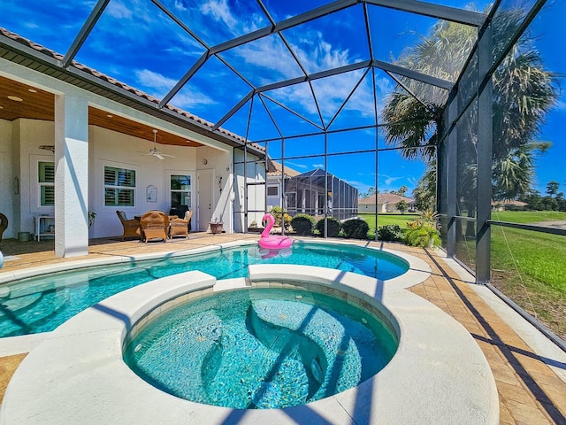 145 Heron Dr, Palm Coast, FL 32137 - view of pool with a pool with connected hot tub, a patio area, a ceiling fan, and glass enclosure