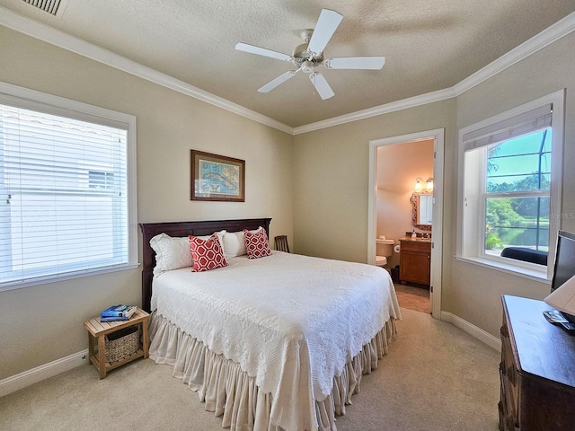 145 Heron Dr, Palm Coast, FL 32137 - bedroom with light carpet, multiple windows, ornamental molding, a textured ceiling, and ensuite bath