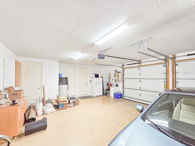 145 Heron Dr, Palm Coast, FL 32137 - garage featuring freestanding refrigerator and a garage door opener