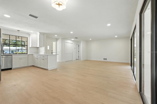 43 Courtney Pl, Palm Coast, FL 32137 - kitchen with stainless steel dishwasher, a peninsula, recessed lighting, white cabinets, and open floor plan
