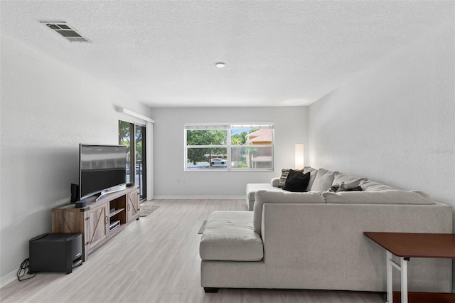4600 E Moody Blvd Unit 14O, Bunnell, FL 32110 - living area with light wood-type flooring and a textured ceiling