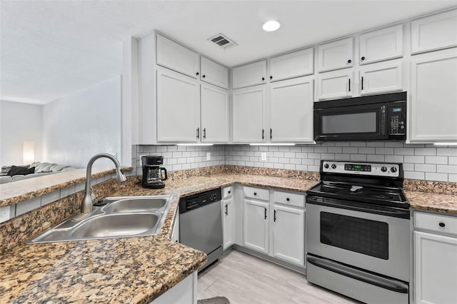 4600 E Moody Blvd Unit 14O, Bunnell, FL 32110 - kitchen with stainless steel appliances and white cabinetry