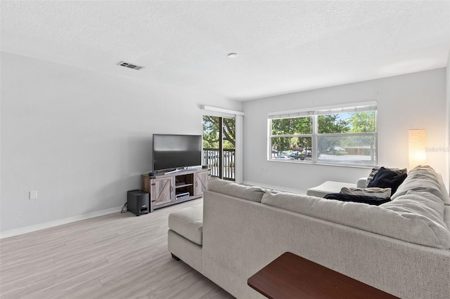 4600 E Moody Blvd Unit 14O, Bunnell, FL 32110 - living area with light wood-type flooring and a textured ceiling