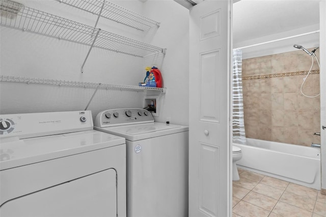 4600 E Moody Blvd Unit 14O, Bunnell, FL 32110 - washroom with light tile patterned floors and washer and clothes dryer