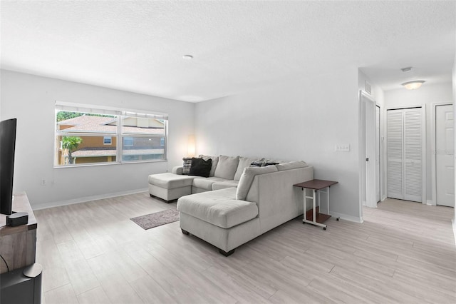 4600 E Moody Blvd Unit 14O, Bunnell, FL 32110 - living room with light wood-style floors and a textured ceiling
