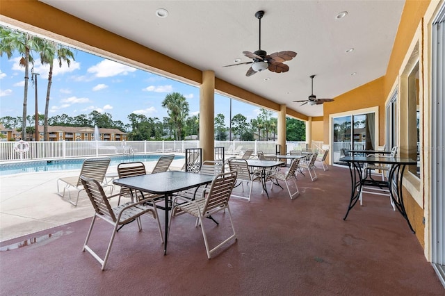 4600 E Moody Blvd Unit 14O, Bunnell, FL 32110 - view of patio with a community pool, ceiling fan, and outdoor dining area