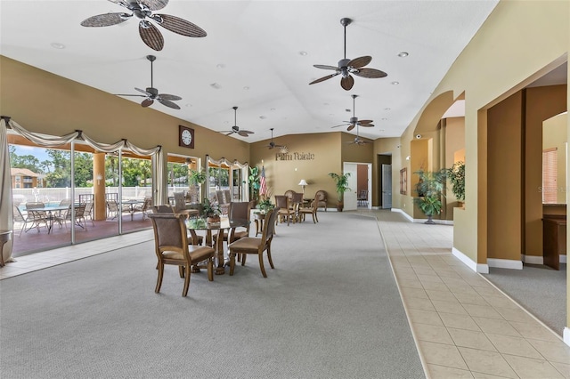 4600 E Moody Blvd Unit 14O, Bunnell, FL 32110 - dining area with light carpet, light tile patterned floors, a ceiling fan, high vaulted ceiling, and arched walkways