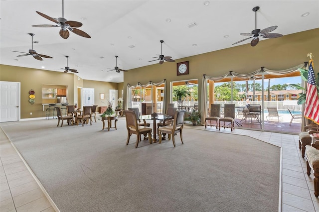 4600 E Moody Blvd Unit 14O, Bunnell, FL 32110 - dining space featuring light tile patterned floors, high vaulted ceiling, ceiling fan, light colored carpet, and recessed lighting