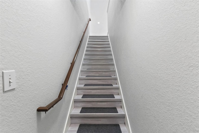 4600 E Moody Blvd Unit 14O, Bunnell, FL 32110 - staircase with a textured wall and wood finished floors