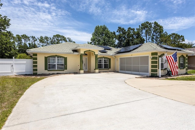 25 Raintree Pl, Palm Coast, FL 32164 - view of front of property with a tiled roof, stucco siding, an attached garage, and driveway