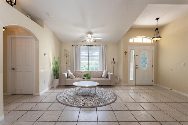 25 Raintree Pl, Palm Coast, FL 32164 - foyer entrance featuring light tile patterned floors, healthy amount of natural light, a ceiling fan, arched walkways, and lofted ceiling