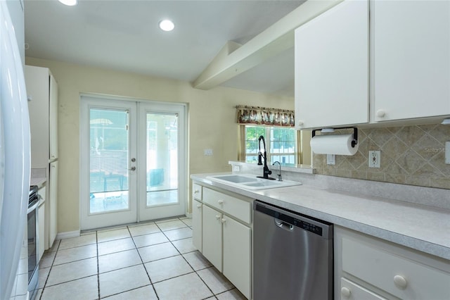 25 Raintree Pl, Palm Coast, FL 32164 - kitchen with appliances with stainless steel finishes, french doors, light countertops, tasteful backsplash, and white cabinets